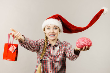 Christmas woman holding shopping bag and brain
