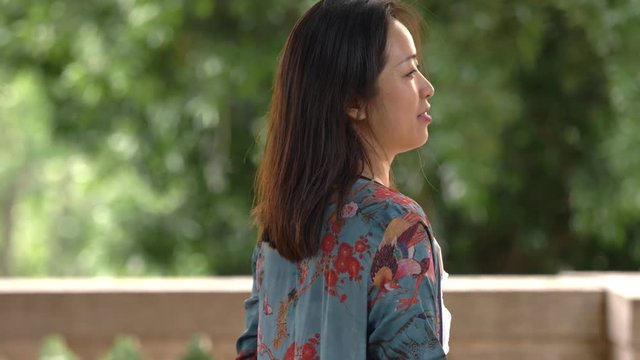 Relaxed beautiful asian woman in teh park contemplating nature