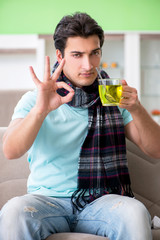 Young handsome man suffering from illness at home 