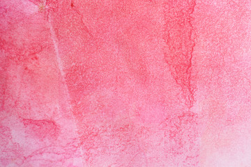 watercolor paper background with red pink paint. water spread