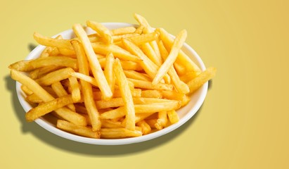 Plate of french fries on wooden table