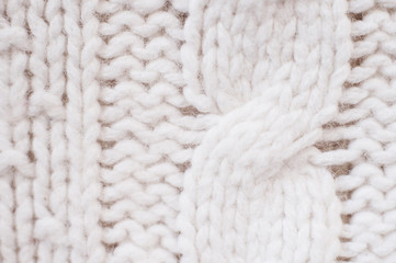 Knit texture of white wool knitted fabric with cable pattern as background