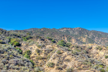View of mountains on clear morning with blue sky for text
