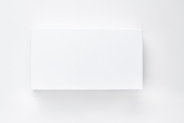 White paper box with shadow on a white background isolate. Empty card mock up