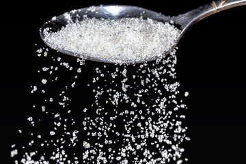 teaspoon with sugar dunes and granulated sugar