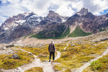 Young man taking a choice, making a decision, about what way to take, with three options of path that lead to adventure, to nature and exploration, near campsite De Agostini, in El Chalten, Patagonia