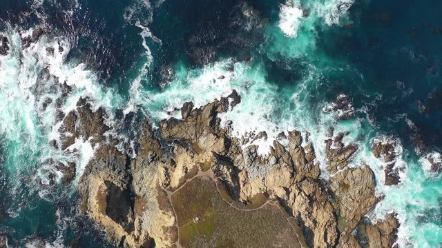 Aerial View of Ocean Washing Onto Rocky California Coastline