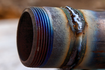 fresh weld bead on a metal tube macro