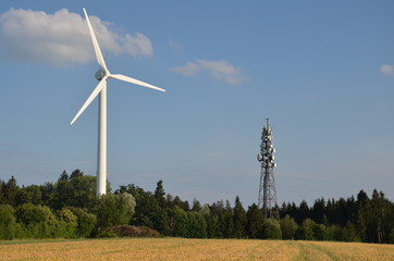 Wind Turbine in a natural scenery with fields and forests