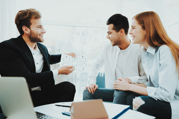 Young Couple Meeting With Rieltor. Bright Office.