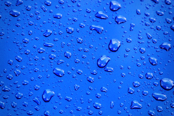 rain drops on blue car body, shallow focus