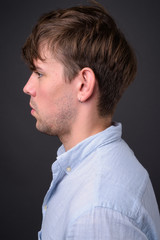 Fototapeta premium Studio shot of young handsome man against gray background