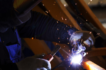 Industrial Worker at the factory welding macro