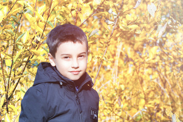 Children's fashion. autumn children's clothing. a boy in a black jacket on a yellow background. informal style. alternative clothing. autumn fashion © justoomm