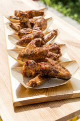 Portion of chicken wings grilled in trays