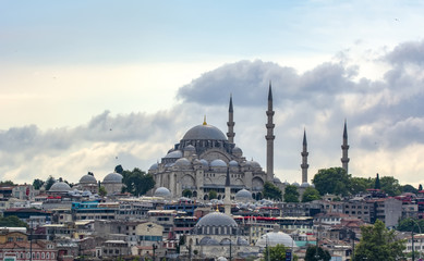Obraz premium Touristic landmarks from sea voyage on Bosphorus. Cityscape of Istanbul at sunset - old mosque and turkish steamboats, view on Golden Horn.