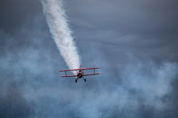 Fototapeta na wymiar Biplane with White Smoke