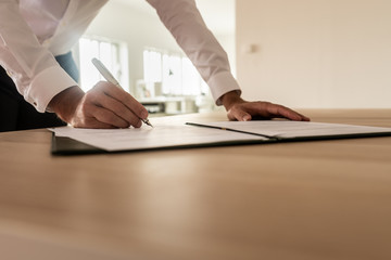 Businessman signing insurance or legal document