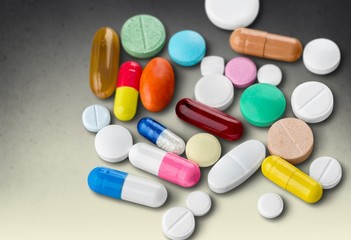 Colorful pills and tablets on background