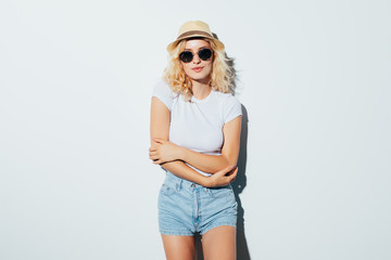 Portrait of a pretty beautiful blonde wearing beach hat on the white background
