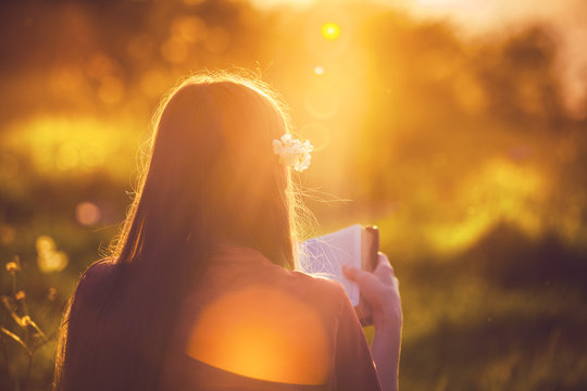 Girl Reading The Bible At Sunset