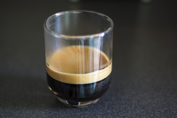 Espresso coffee with foam on a transparent cup