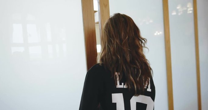 Young attractive woman entering empty lecture holl