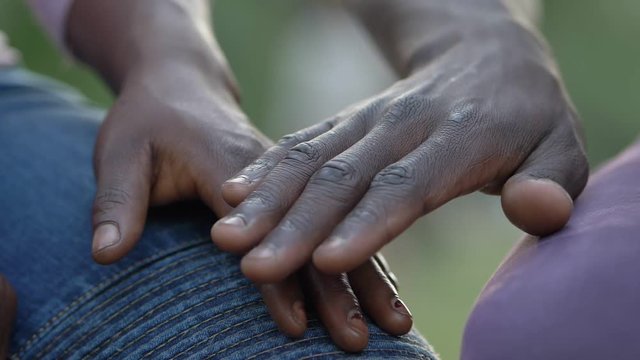 love among black people. hands of young Africans touch each other- slow motion
