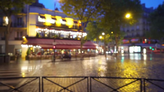 Lovely twilight scene of restaurant on a rainy street in Paris France