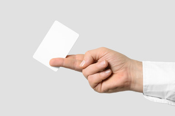 Mockup of male hand holding a Business Card isolated on light grey background. Rounded corner, Europe standard size 85×55 mm.