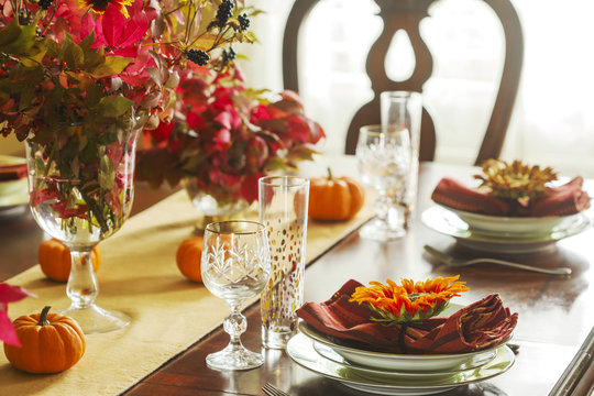 Thanksgiving table setting. Autumn table setting with small pumpkins