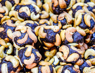 Slices of marmalade with cashew nuts. Cashews with sweets. Marmalade balls with nuts