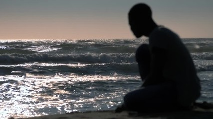 Refugees,migration,human rights.silhouette of sad black man alone at the beach