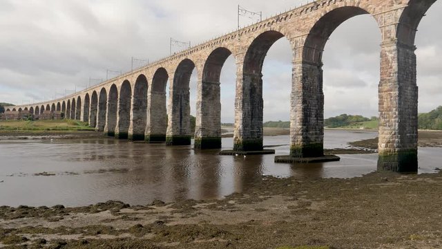 River Tweed at low tide flows under iconic Royal Borders Bridge built in 1850 as a railroad bridge at Berwick-Upon-Tweed, Northumberland, England