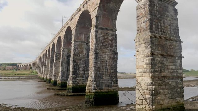 River Tweed at low tide flows under iconic Royal Borders Bridge built in 1850 as a railroad bridge at Berwick-Upon-Tweed, Northumberland, England