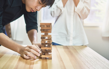 women and teamwork making a pyramid with empty wooden cubes. Business concept with step-by-step for a firm basis.