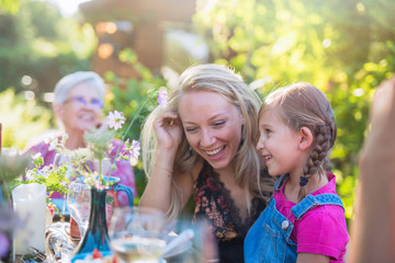 Summertime, cheerful family gathered for picnic in the garden