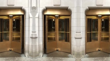 An endlessly looping wall of golden revolving doors on a gothic stone building.