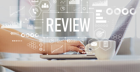 Review with woman using a laptop on a coffee table 
