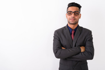 Young Indian businessman wearing suit against white background