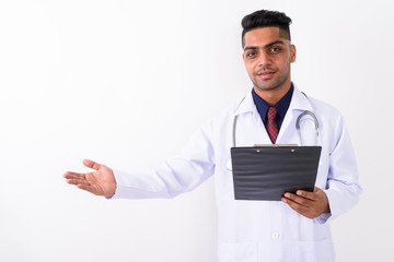 Young Indian man doctor against white background