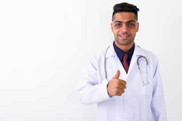 Young Indian man doctor against white background