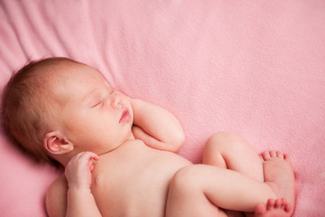 Newborn Baby Girl Sleeping Peacefully, Isolated on Pink