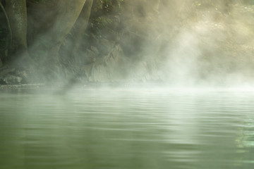 Morning is beautiful fog steam hot spring with sunlight at Hin Dat Hot Spring , Kanchanaburi , Thailand