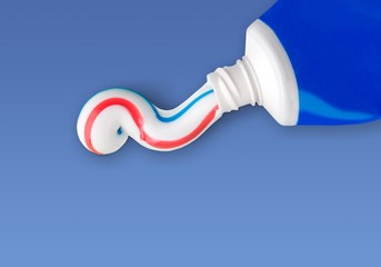 Tube of toothpaste on patel background