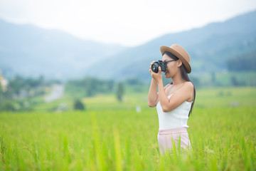Young woman photograph standing in green grassland.