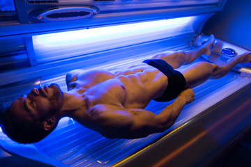 Young Man At Solarium In Beauty Salon