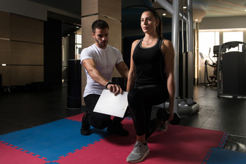 Muscular Couple Exercising With Kettle-bell