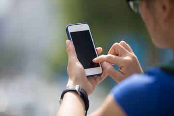 Hands using smartphone in modern city