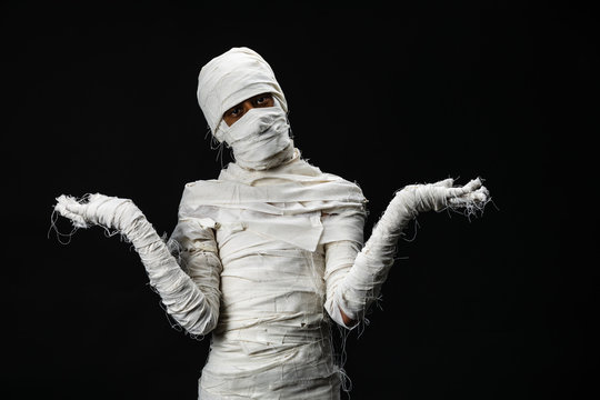 Studio Shot Portrait  Of Young Man In Costume  Dressed As A Halloween  Cosplay Of Scary Mummy Pose Like A Open Hand Acting On Isolated Black Background